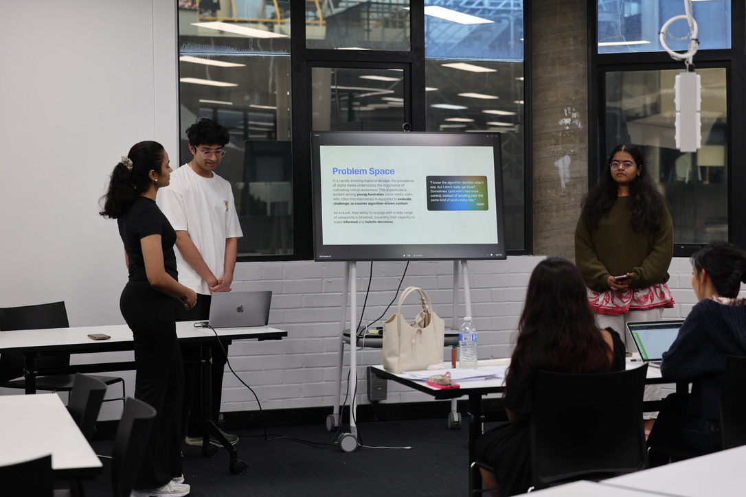 Naman and teammates presenting the Algo solution to a panel of judges on a screen behind them